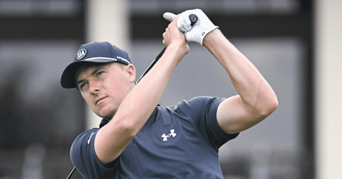 Image of Jordan Spieth reacts to almost hitting a fan on the golf course.