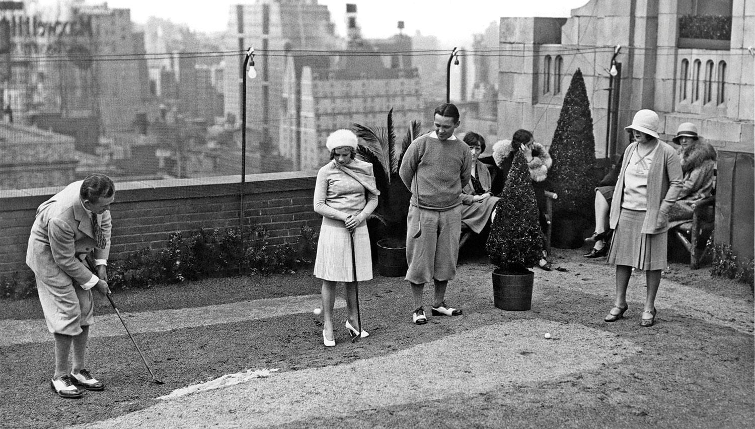 Golf pro Charles Mothersele at the Hotel Victoria’s 18-hole mini-golf roof course, sometime near 1927. Pro Jack Redmond looks on along with Miss Chita Hawking and Mary Lee